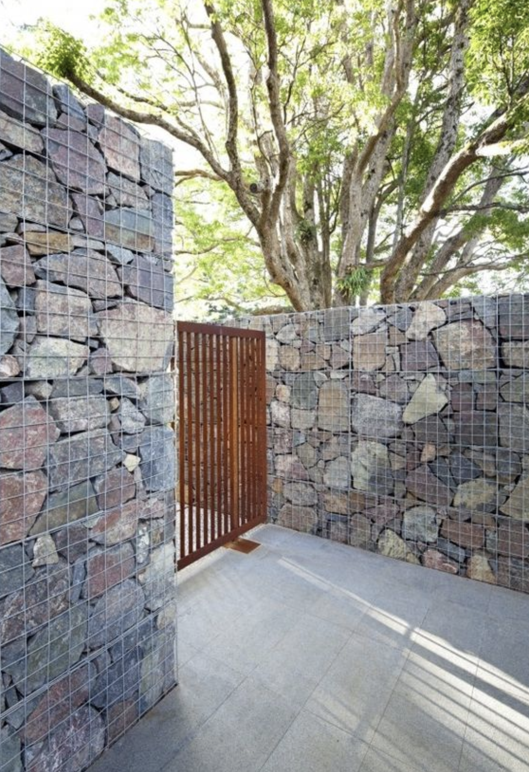 modern fence design stones and wood